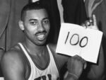 Wilt Chamberlain, of the Philadelphia Warriors, holds a sign reading &quot;100&quot; in the dressing room in Hershey, Pa., March 2, 1962, after he scored 100 points, as the Warriors defeated the New York Knicks. Wednesday marks the 60th anniversary of the greatest scoring effort in NBA history — 36 field goals, 28 free throws, 100 points for Chamberlain, in the Warriors’ 169-147 win in a game played before about 4,000 people in Hershey. It might be the closest thing the NBA has to a single-game record that will never be broken. (AP Photo/Paul Vathis, File)