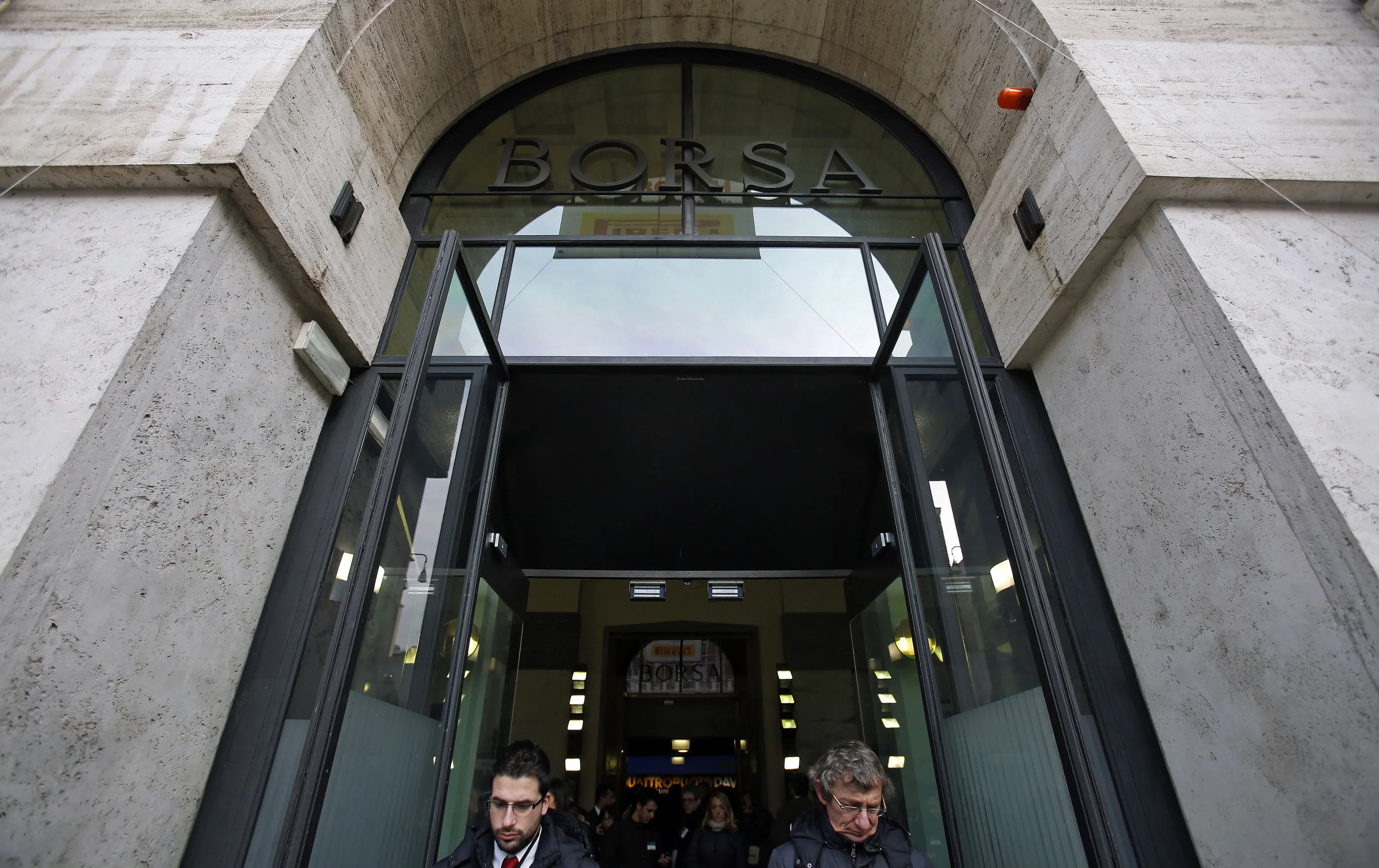 Vistors exit the Borsa Italiana, Italy's stock exchange, which is part of the London Stock Exchange Group Plc, in Milan, Italy, on Thursday, Jan. 17, 2013. The euro-area economy won't return to growth until the next quarter as a recovery in Italy is delayed and France continues to shrink, according to a survey of economists.