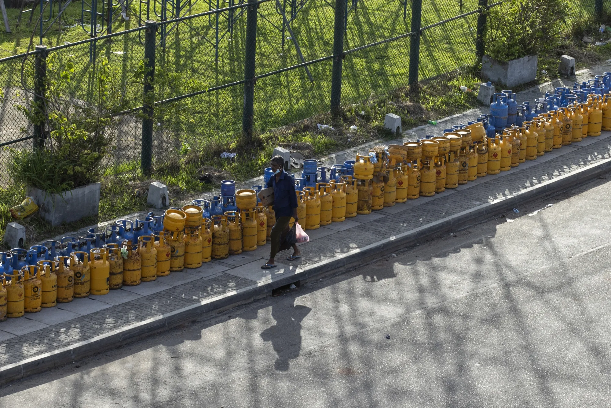 Lines of empty cooking gas cylinders surround the Galle International Cricket Stadium in Galle, Sri Lanka, in June.
