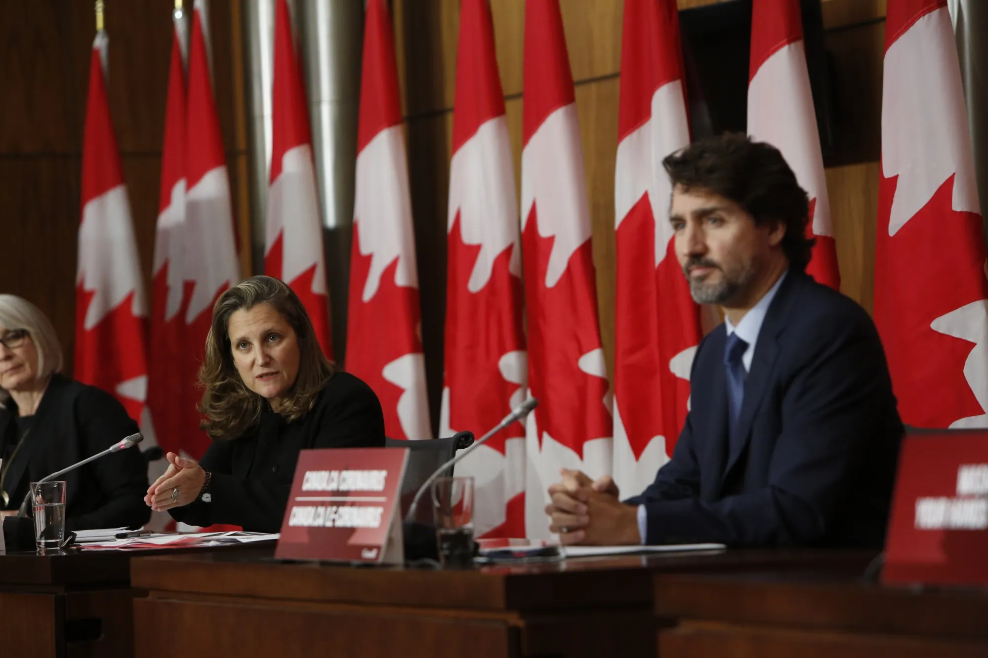 Chrystia Freeland speaks alongside Justin Trudeau at an Ottawa news conference on Oct. 9.