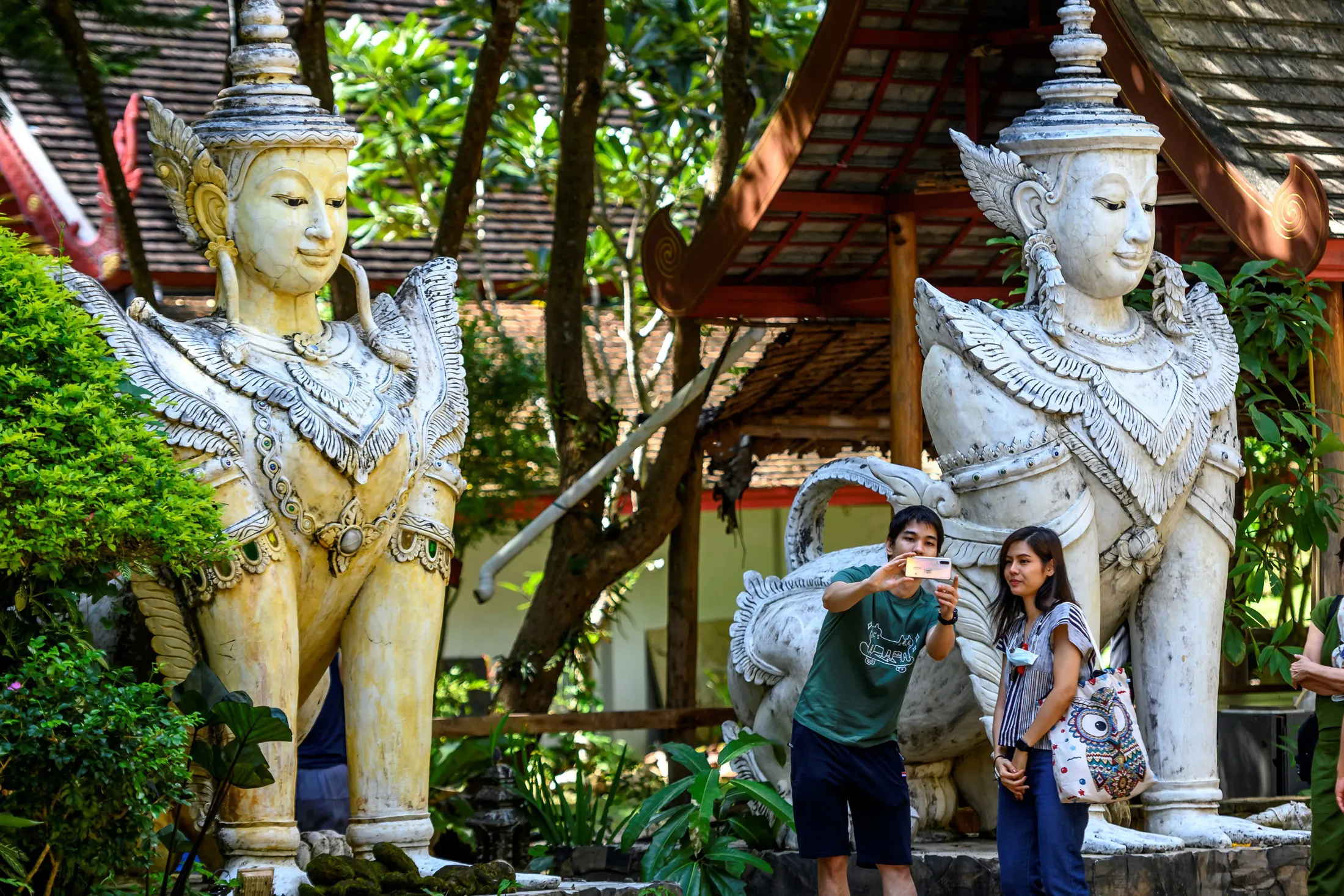 Visitors at a temple in Chiang Mai, Thailand.