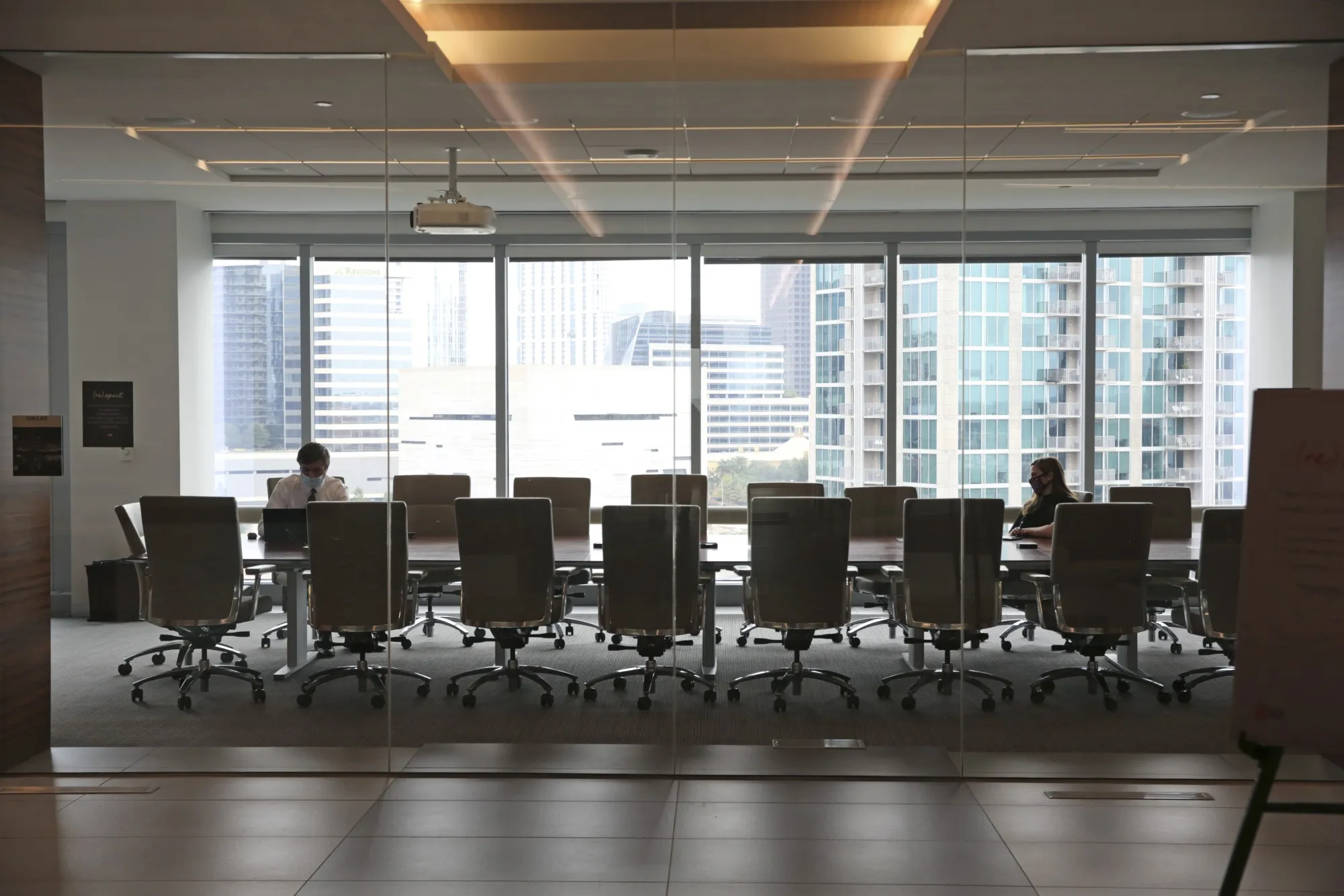 Employees wear protective masks in a conference room at a JLL office in Dallas, Texas, U.S.