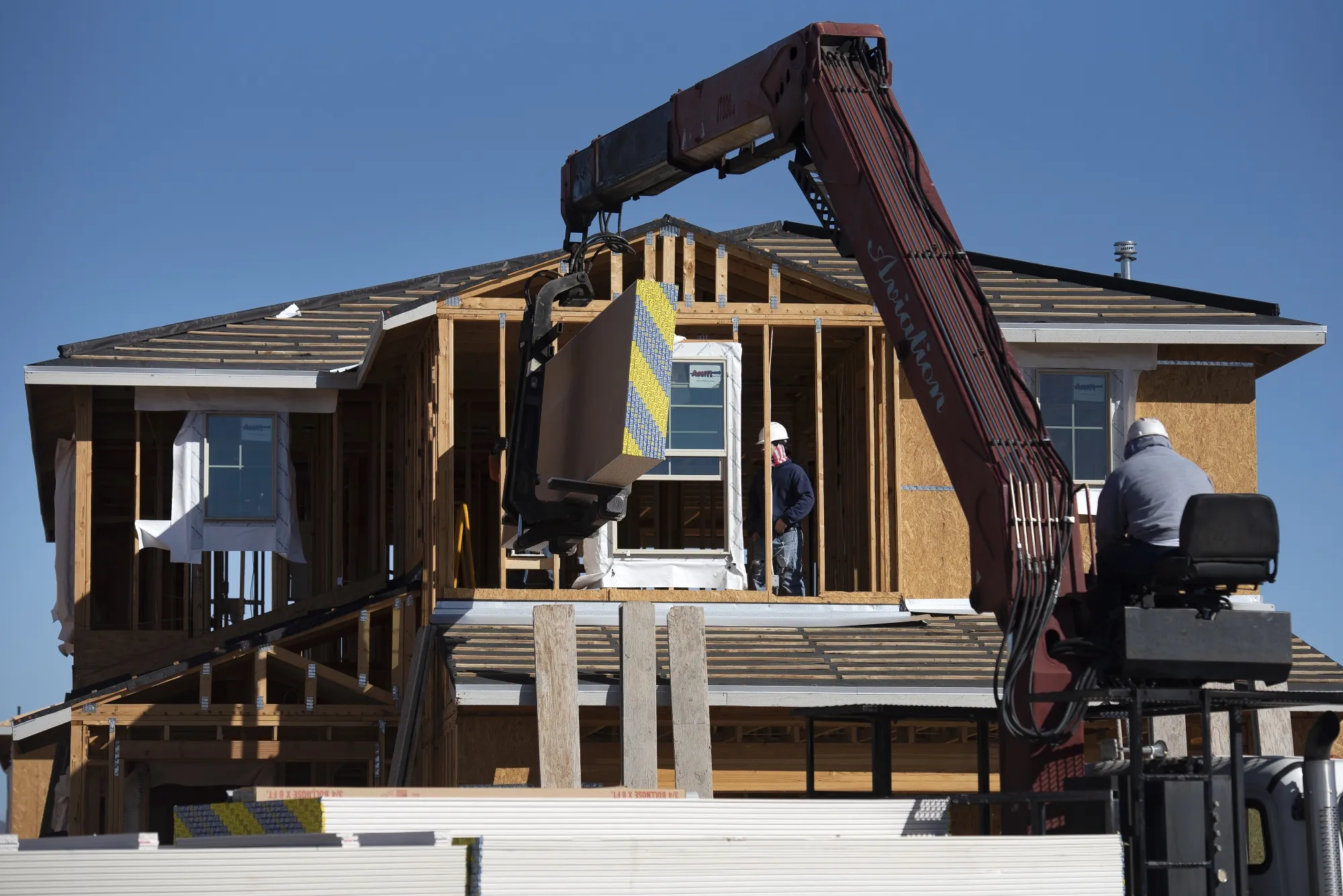 Contractors work on a new home under construction in Tucson, Arizona.