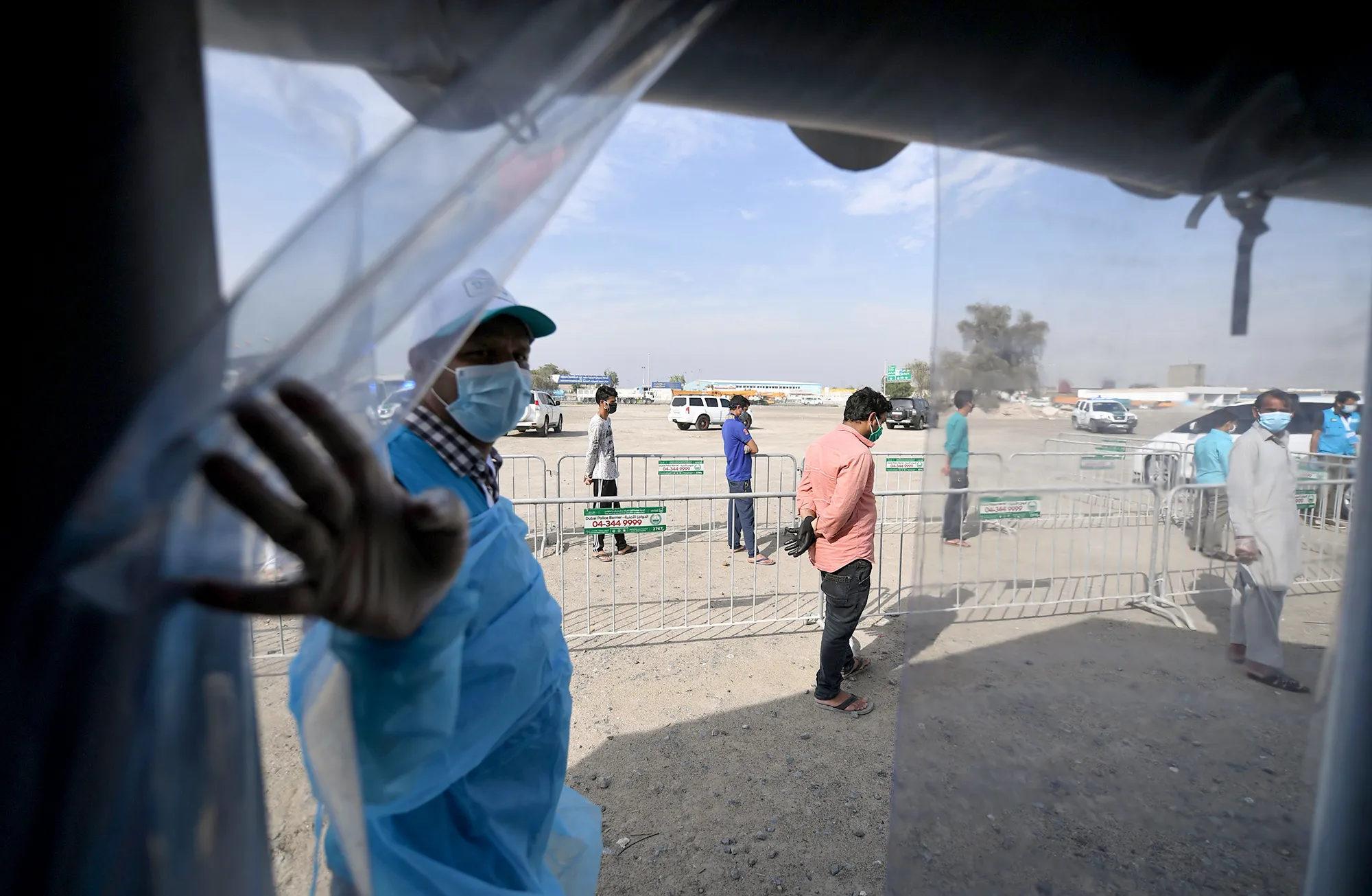People stand in line&nbsp;at a coronavirus testing center in&nbsp;Dubai on April 18.&nbsp;