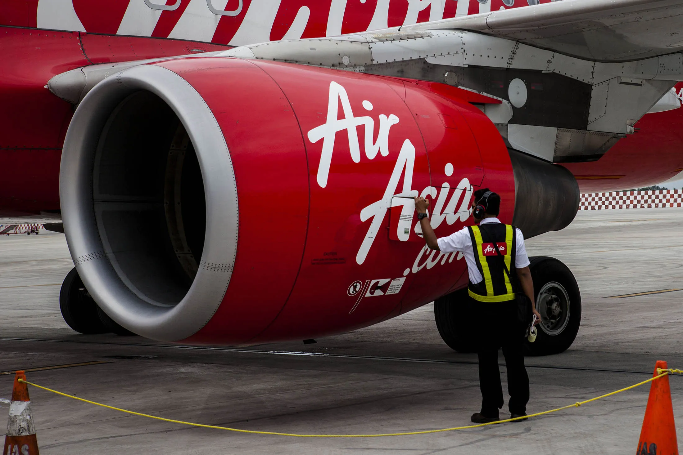 AirAsia Technician checks the airplane for preparation before take off at Soekarno Hatta International Airport.
