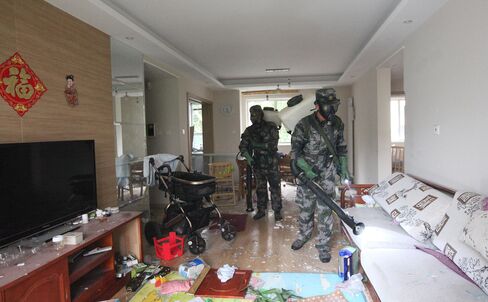 Military personnel decontaminate a home near the warehouse explosion site in Tianjin, China on Tuesday. Photographer: Wang Haobo/Xinhua/Getty Images