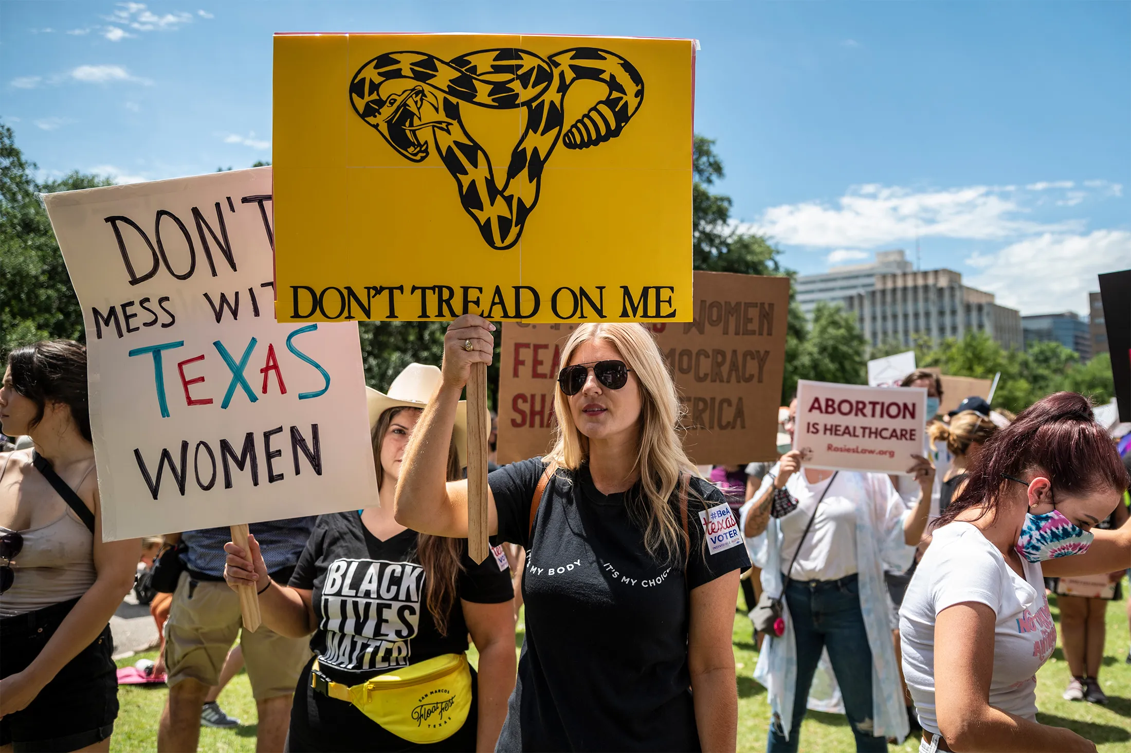 Demonstrators hold up signs at a protest outside the Texas state capitol in Austin on&nbsp;May 29.