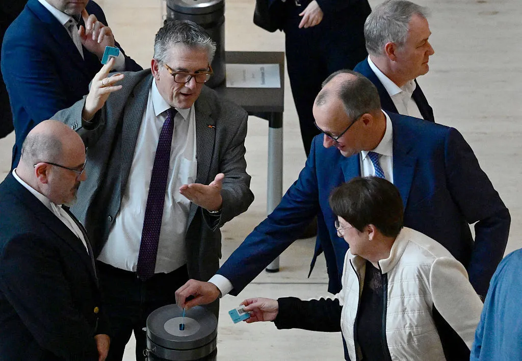 Friedrich Merz casts his ballot for the federal budget 2026 during a debate at the Bundestag, on Nov. 28.