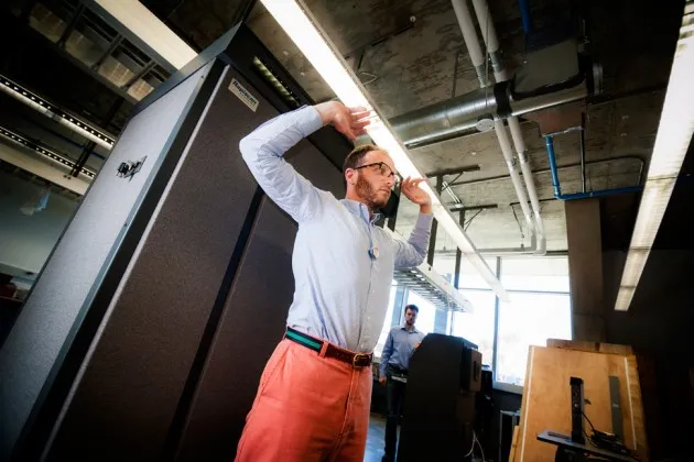Professor Shacham stands in front of the study's  Rapiscan backscatter X-ray scanner