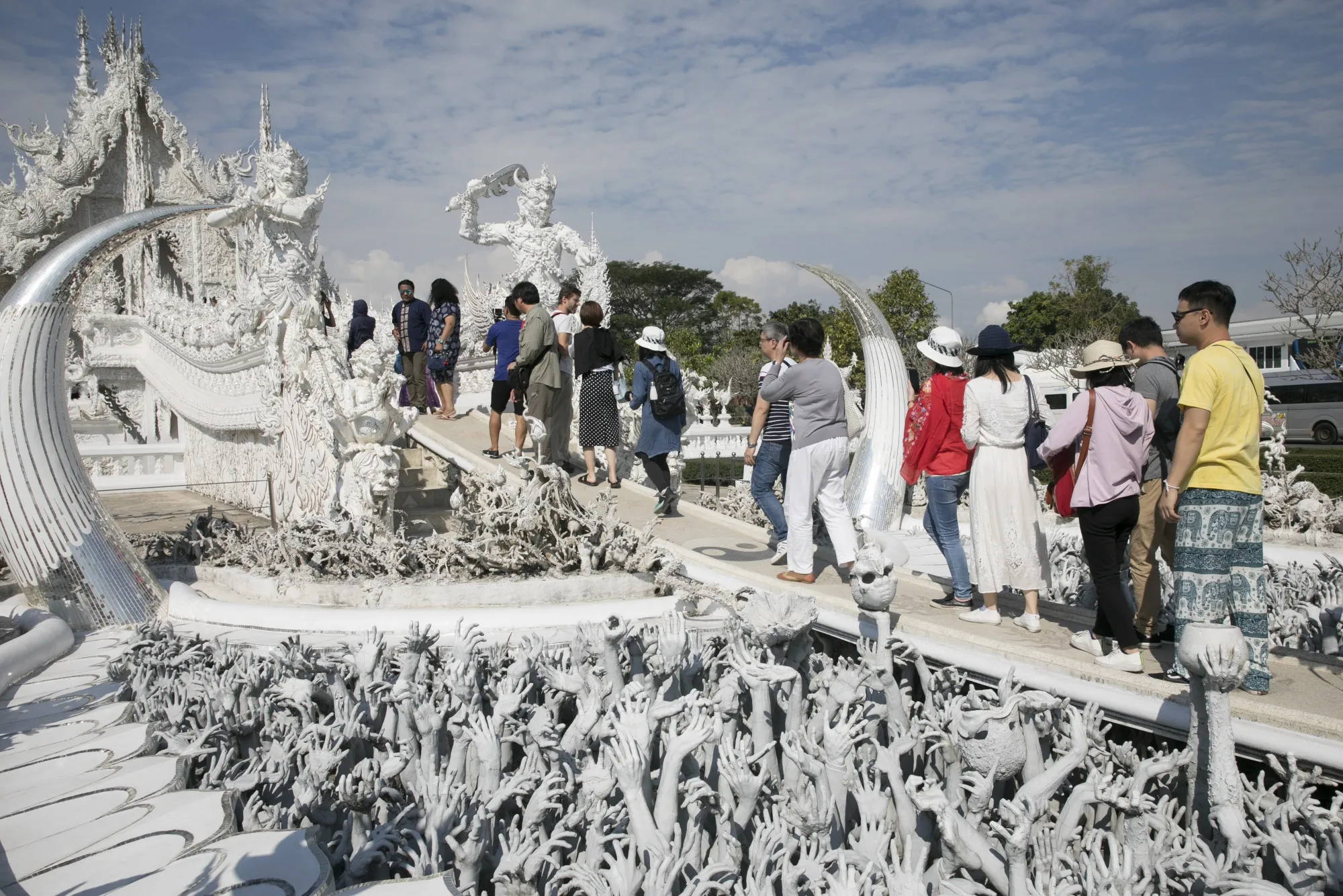 Tourists visit the Wat Rong Khun temple in Chiang Rai, Thailand.