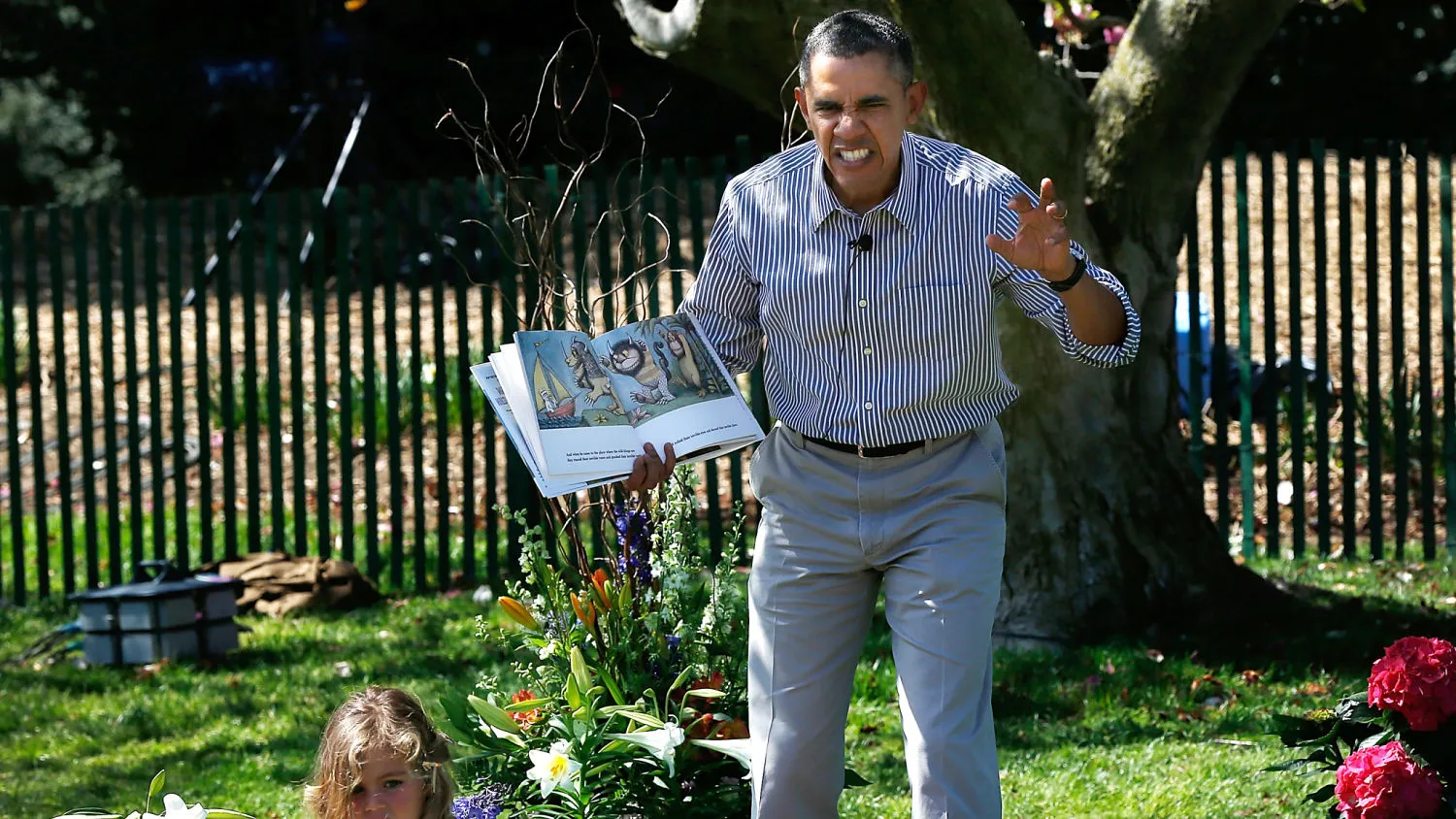 WASHINGTON, DC - APRIL 21: U.S. President Barack Obama read to children from the book "Where the Wild Things Are" during the annual White House Easter Egg Roll on the South Lawn April 21, 2014 in Washington, DC. President Obama and the first lady hosted thousands of children for the annual White House event dating back to 1876 that features live music, sports courts, cooking stations, storytelling, as well as the Easter egg roll this year.
