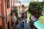 Tourists walk past retail stores and cafes near Lake Como in Bellagio, Italy, on Thursday, Aug. 24, 2017. Italy's economic recovery extended for a tenth straight quarter, boosting optimism that growth can become sustainable this year amid a rise in industrial production.