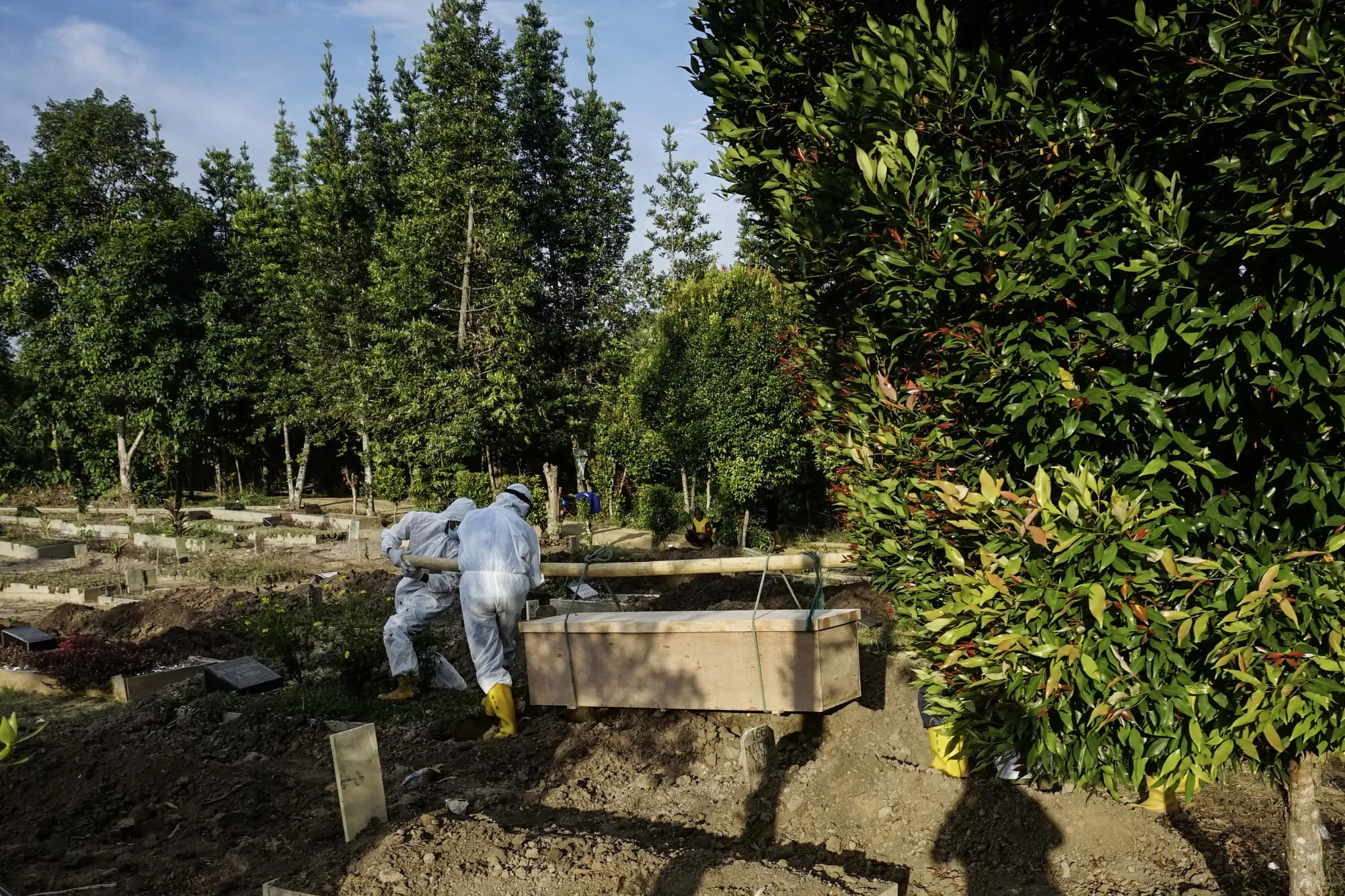 Health workers bury a Covid-19 victim in Palembang, south Sumatra on Aug. 5.