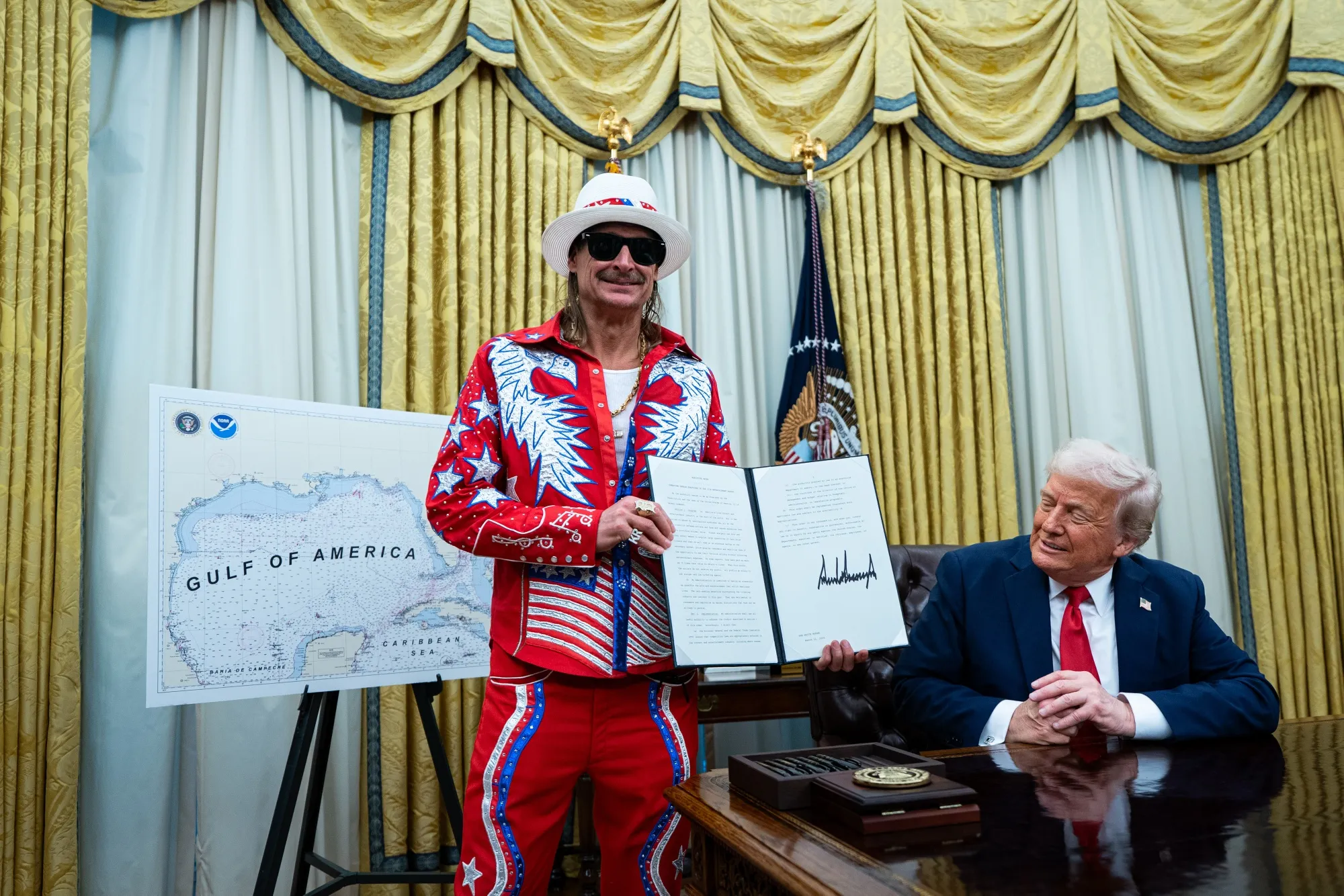 Singer Kid Rock, left, and US President Donald Trump during an executive order signing in the Oval Office of the White House in Washington, DC, US, on Monday, March 31, 2025. The order directs the Federal Trade Commission to work with the Department of Justice to ensure that competition laws are enforced in the concert and entertainment industry, and pushes state consumer protection authorities on enforcement.