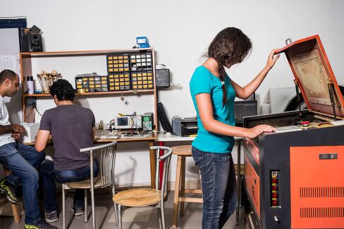 Members of Fab Lab Egypt use a laser cutter on May 18 in Cairo.