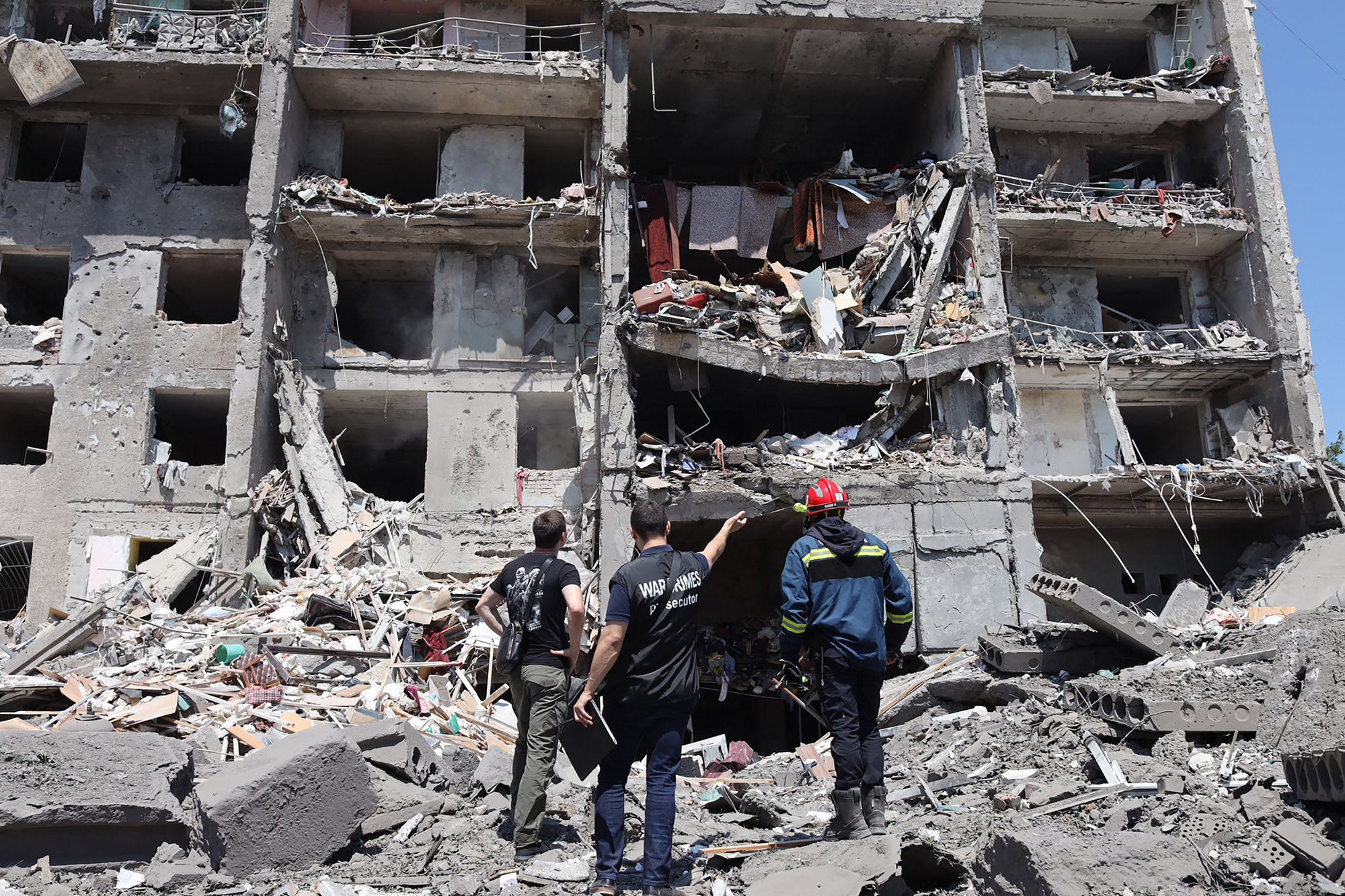Officials&nbsp;look at a destroyed building after being hit by a missile strike in Sergiyvka, near Odessa, on July 1.