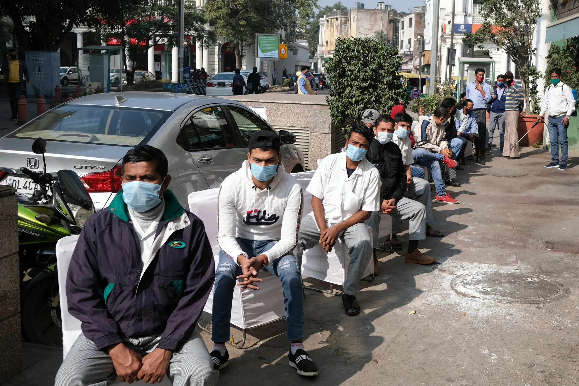 People wait in line to register at a Covid-19 reverse transcription polymerase chain reaction (RT-PCR) test site in New Delhi.