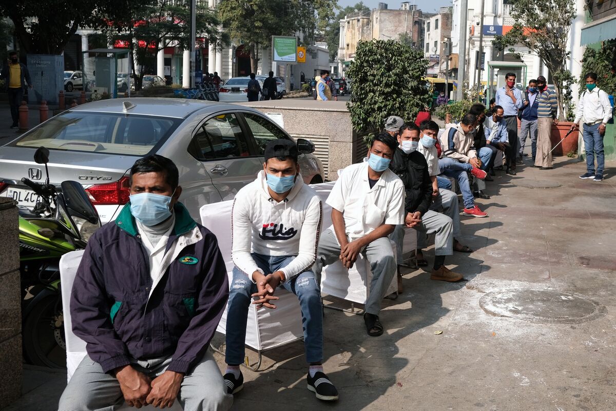 People wait in line to register at a Covid-19 reverse transcription polymerase chain reaction (RT-PCR) test site in New Delhi.