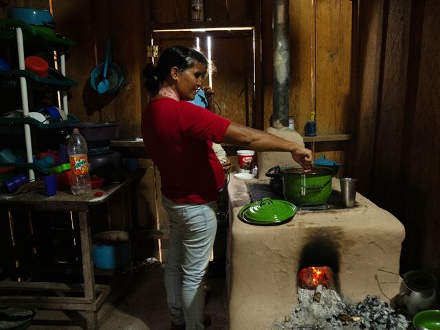 Maria Andino, Omar’s wife, prepares a traditional dinner of beans and corn tortillas at the family home.