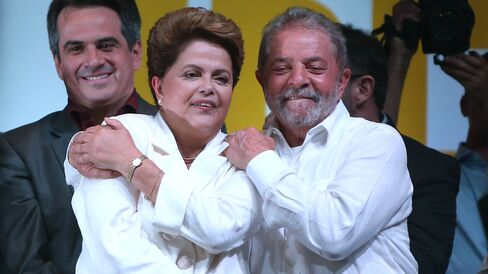 Brazilian President and Workers' Party (PT) candidate Dilma Rousseff (C) celebrates with Brazil's former president Luiz Inacio Lula Da Silva (R) after being re-elected on October 26, 2014 in Brasilia, Brazil.