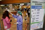 A medical staff checks the temperature of a resident at a Covid-19 vaccination center in New Taipei City, on May 23.
