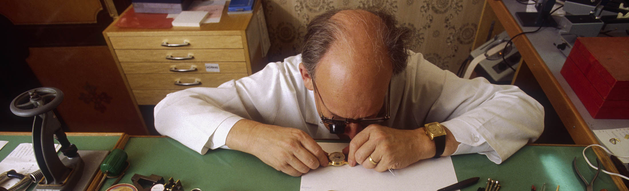 A Patek Philippe watchmaker at work in Geneva, circa 1983.

