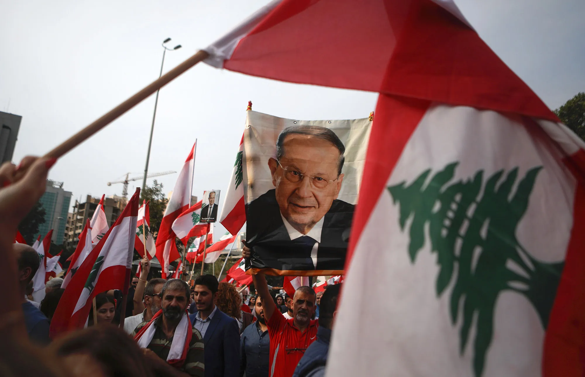 Supporters of Michel Aoun hold his portrait during a demonstration in Beirut on Oct. 25.