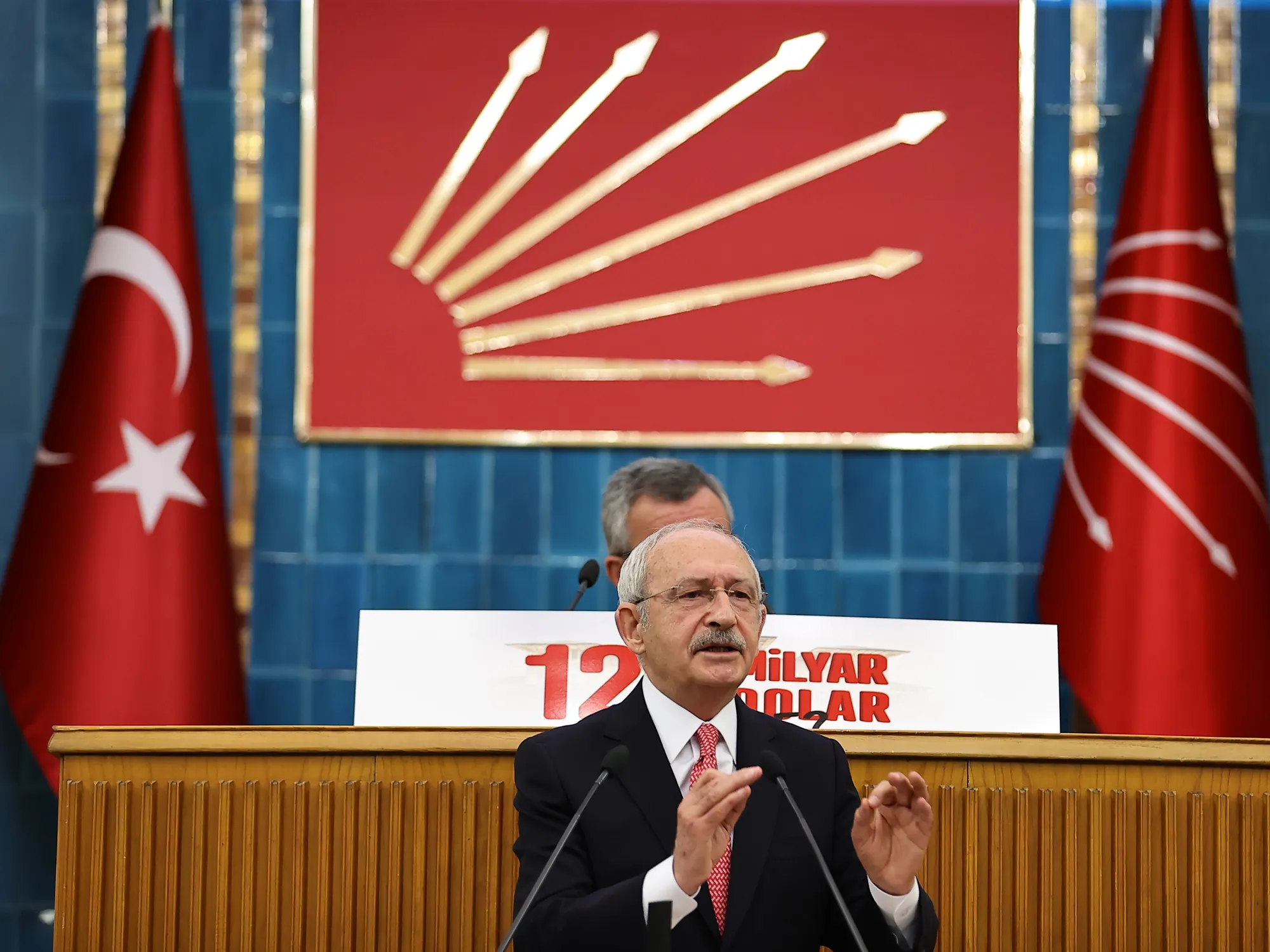Republican People’s Party chairman Kemal Kilicdaroglu speaks in front of a “Where is the $128 billion?” sign in Ankara, on April 13.&nbsp;