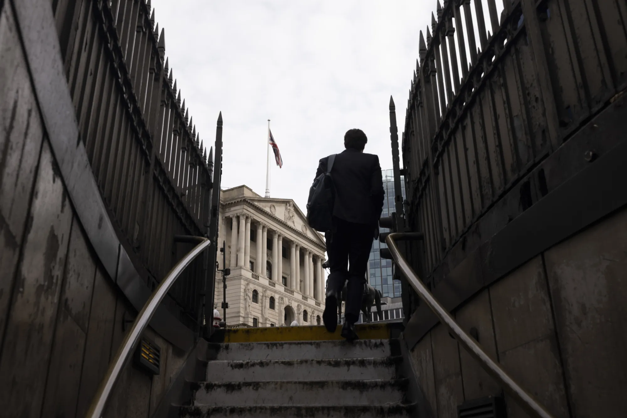 A commuter passes the Bank of England in the City of London.