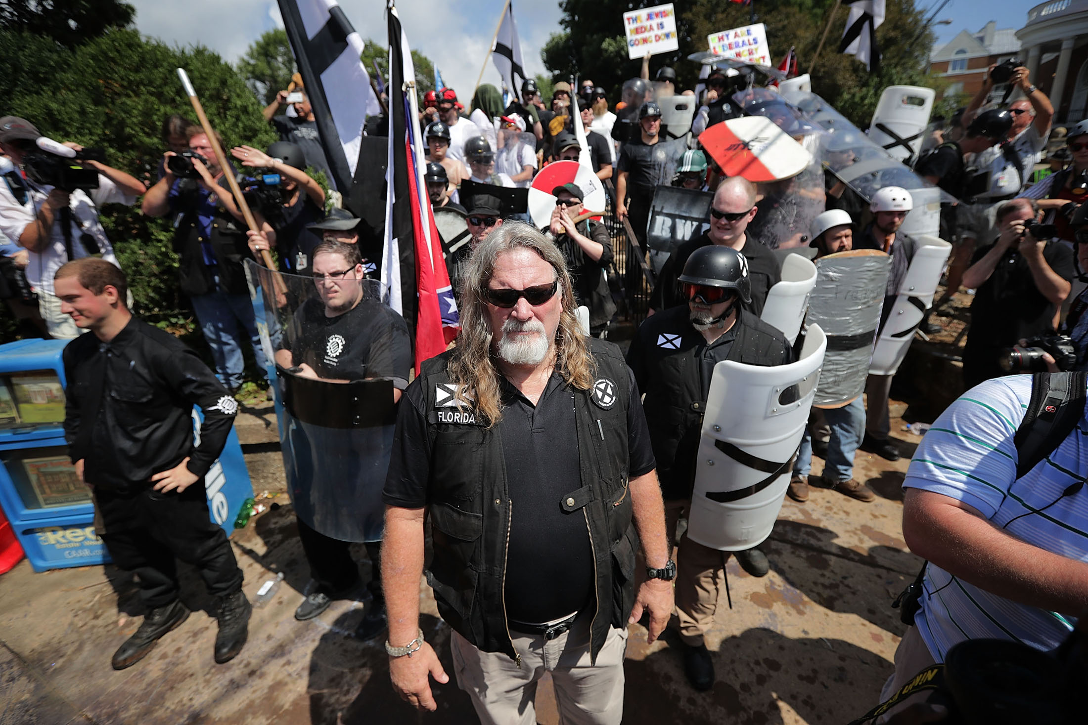 CHARLOTTESVILLE, VA - AUGUST 12: White nationalists, neo-Nazis and members of the 'alt-right' exchange insluts with counter-protesters as they attempt to guard the entrance to Emancipation Park during the 'Unite the Right' rally August 12, 2017 in Charlottesville, Virginia. After clashes with anti-fascist protesters and police the rally was declared an unlawful gathering and people were forced out of Emancipation Park, where a statue of Confederate General Robert E. Lee is slated to be removed.
