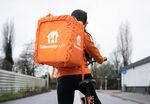 A delivery rider carries a customer's order in Amsterdam.