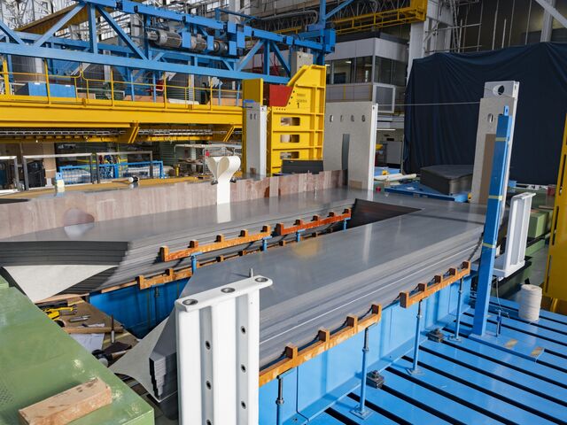 Thin insulated steel sheets are stacked.