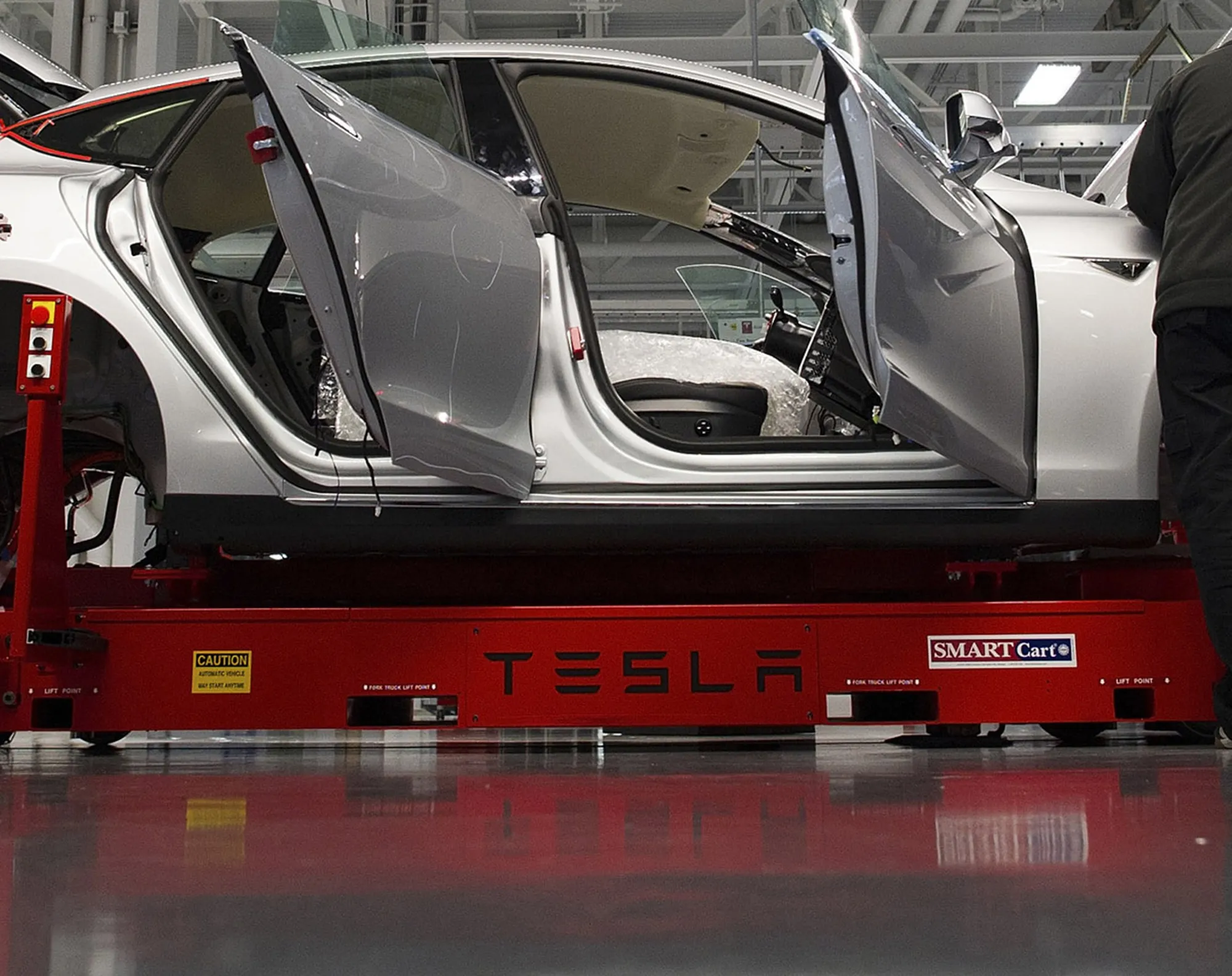 Tesla Motor Inc. associates work on a Model S electric car at the company's factory in Fremont, California.