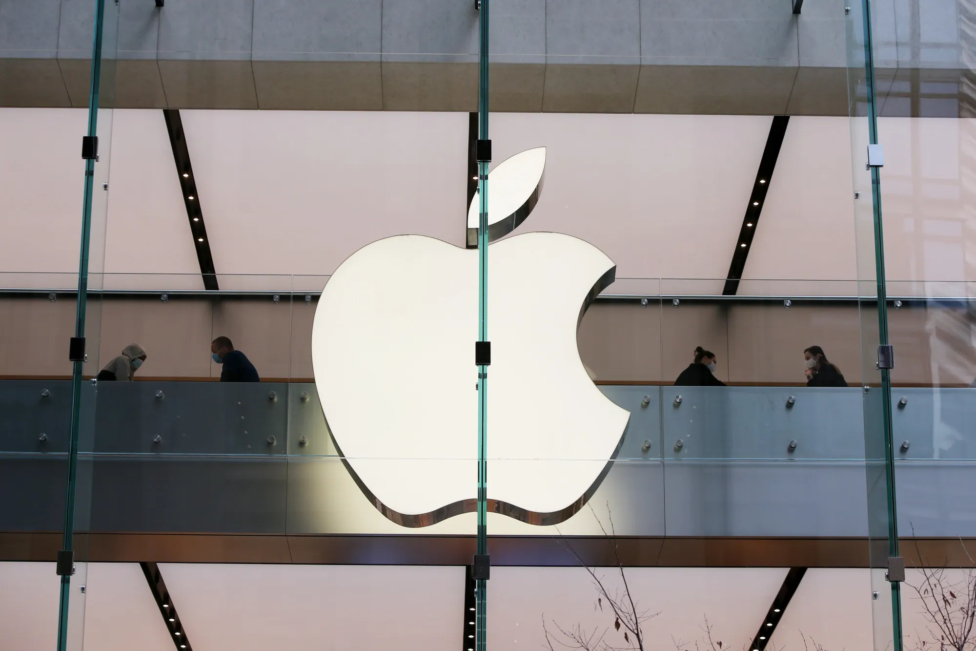 Shoppers wear protective masks while visiting an Apple Inc. store at George Street in Sydney, Australia.