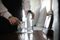 Room service hotel staff placing bottled water and glass at bedside in hotel room