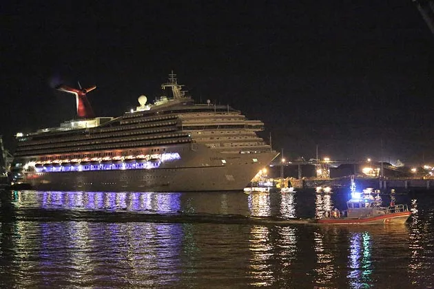 The Carnival cruise ship Triumph makes its way up Mobile Bay assisted by tug boats in Mobile, Alabama on Feb. 14.
