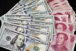 Yuan And Dollar Banknotes Ahead Of Tenth Anniversary Of China's Yuan Reform