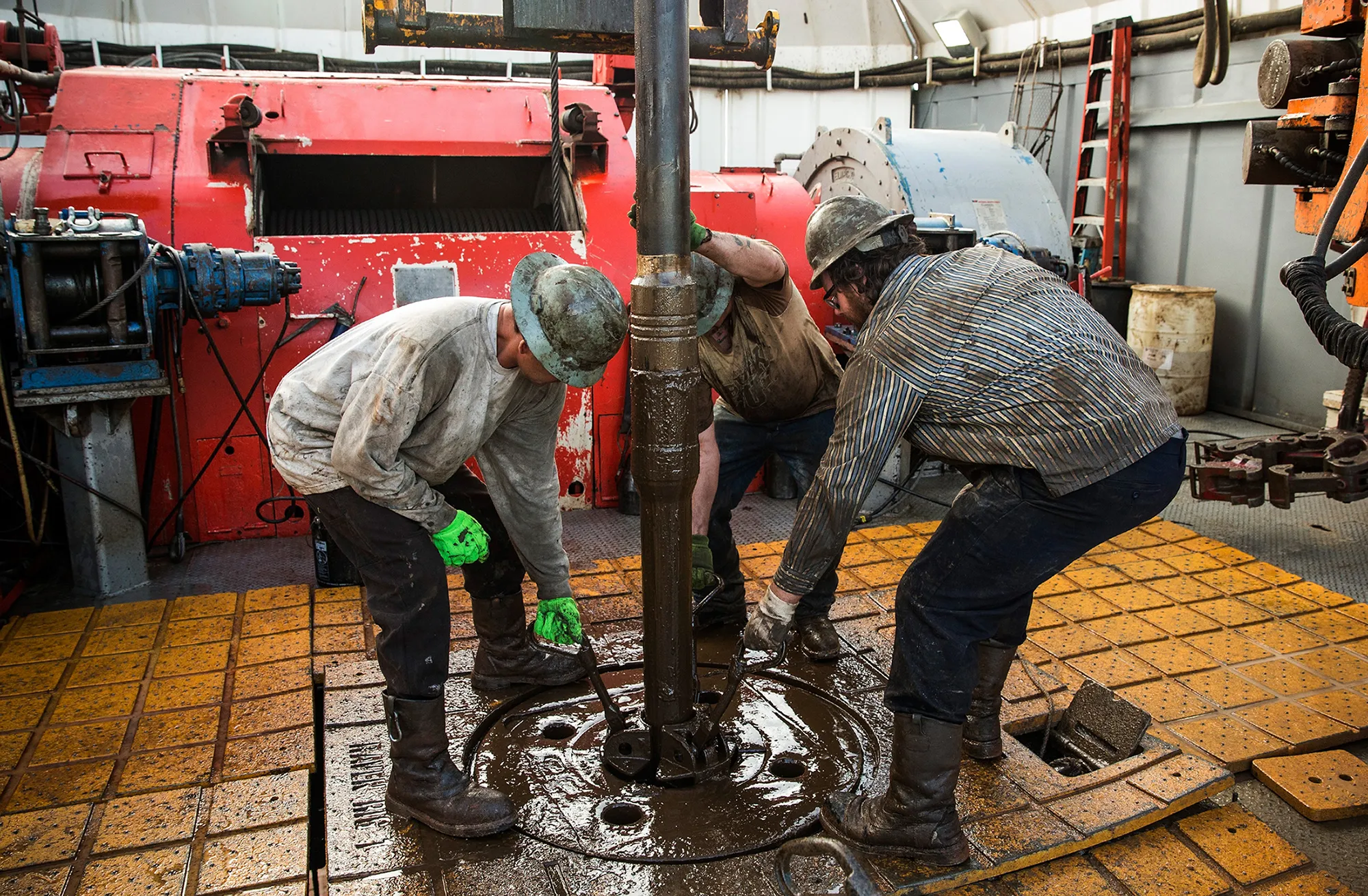 Workers with drilling for oil in the Bakken shale formation on July 23, 2013 outside Watford City, North Dakota.
