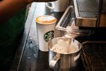 A barista prepares a customers coffee order inside a Starbucks Corp.