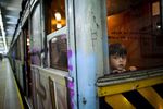 A child looks through the window of a wooden carriage car on the historic subway system, Line A, in Buenos Aires, Argentina, Wednesday, Jan. 2, 2013. 