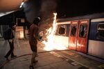 Pro-democracy protesters attempt to burn a MTR train during a demonstration at Chinese University of Hong Kong/