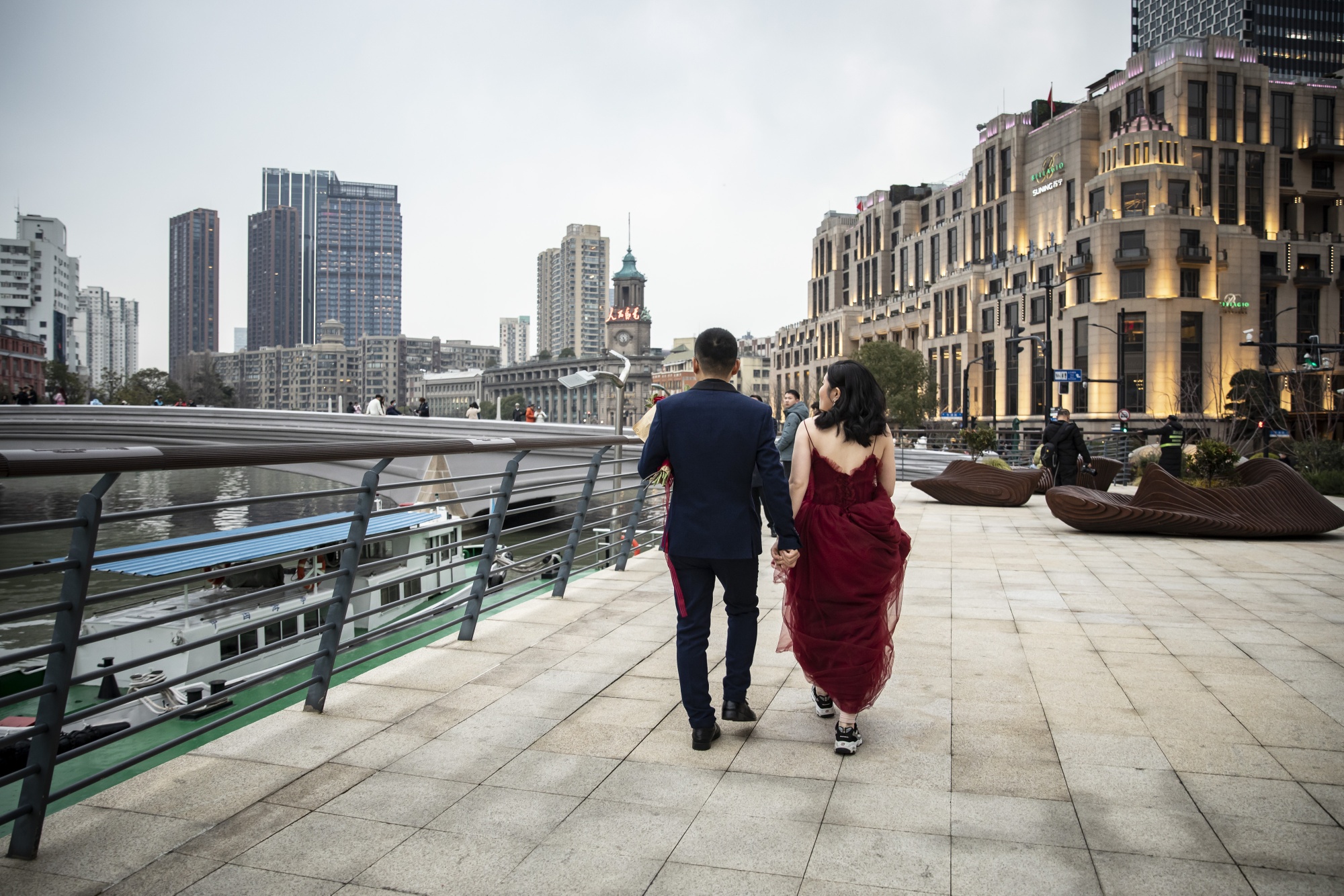 A couple has their wedding photographs taken along the Bund in Shanghai.