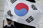 An honor guard member holds a South Korean flag in Washington, D.C., U.S..