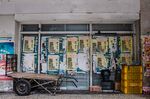 Signs plastered on buildings in downtown Rio de Janeiro blame President Jair Bolsonaro for surging food prices. 