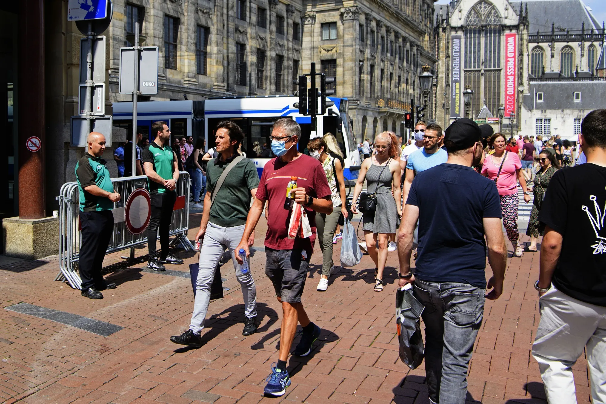 Security personnel, left, control the crowd at Kalverstraat street, in Amsterdam, on July 18.