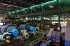 Workers walk past machinery in the mineral selection shop at the Dongguashan Copper Mine, operated by Tongling Nonferrous Metals Group Co., in Tongling, Anhui province, China, on Thursday, Jan. 17, 2019. On the heels of record refined copper output last year, China's No. 2 producer, Tongling, says it'll defy economic gloom and strive to churn out even more of the metal in 2019.