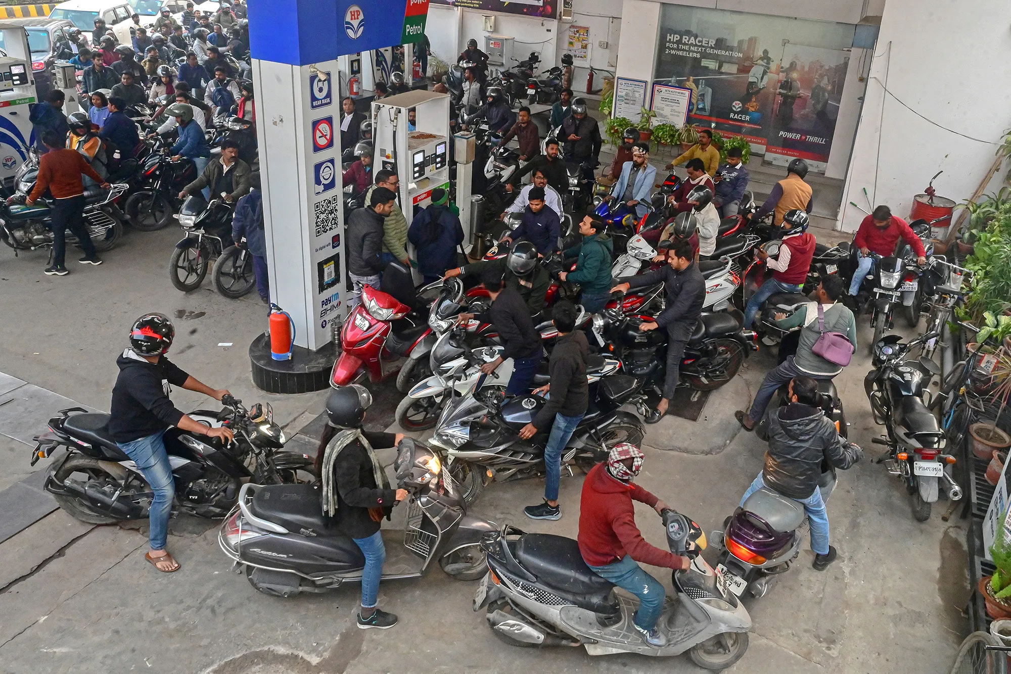 People wait to refill fuel tanks at a fuel station as people rushed to fill their tanks expecting fuel to run out in Prayagraj, India on Jan.&nbsp;2.