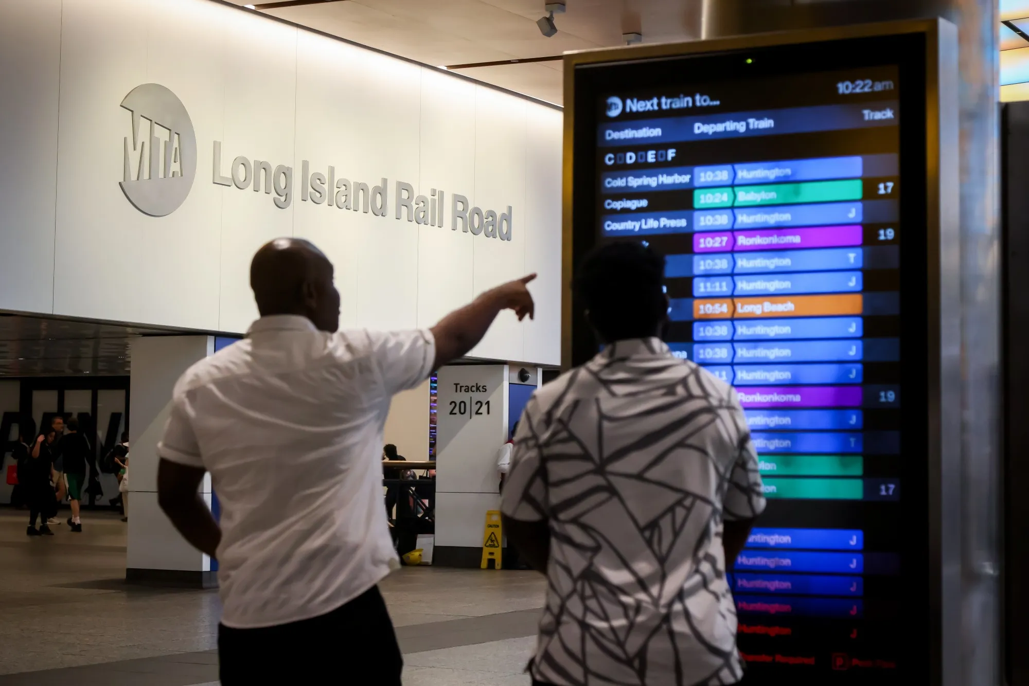 Commuters look at a Long Island Rail Road (LIRR) departures board in New York on Sept. 15.