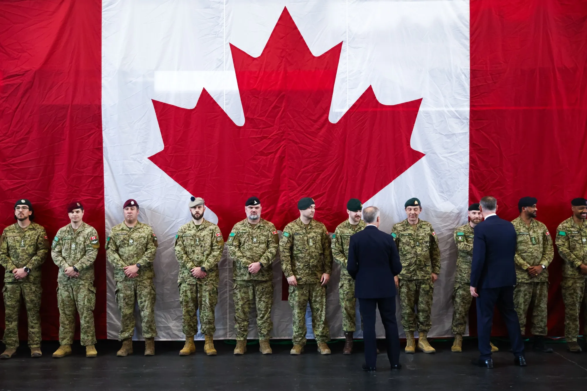Canadian Prime Minister Mark Carney and Minister of National Defence David McGuinty greet Canadian troops of the 4th Canadian Division on June 9, 2025 in Toronto.