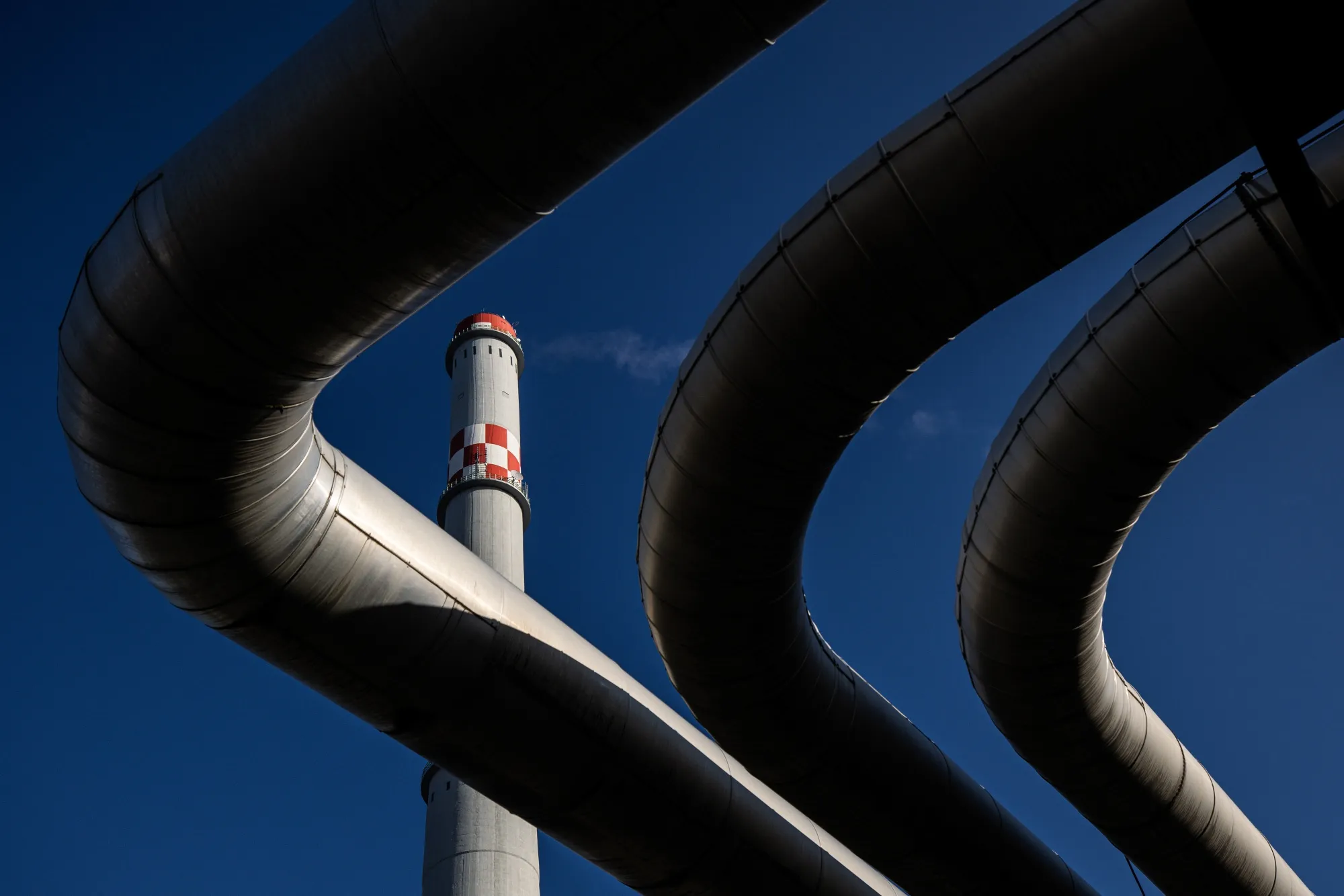 A chimney and pipes at a power plant in Hungary.